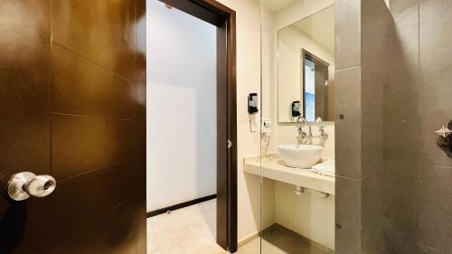 a bathroom with a sink and a mirror at Hotel MAYARI Holbox in Holbox Island