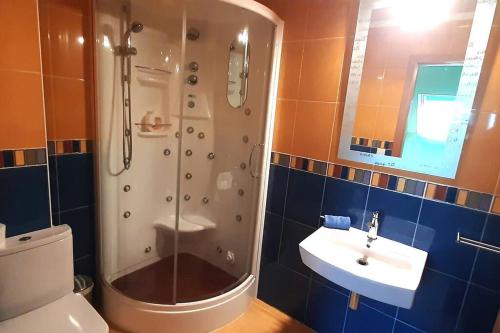 a bathroom with a shower and a toilet and a sink at DUPLEX 3 DORMITORIOS PLAYA FOZ in Foz