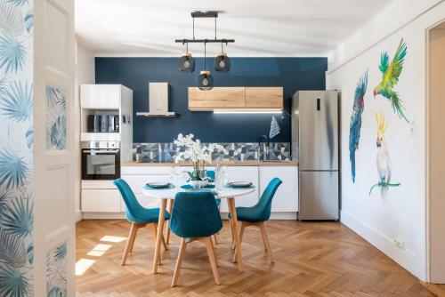 cocina con mesa y sillas azules en Jungle Paradise - Casa Vostra - Gaillard proche tram-frontière, en Gaillard
