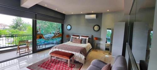 a bedroom with a bed and a large window at RIVER CITY Studio in Larisa