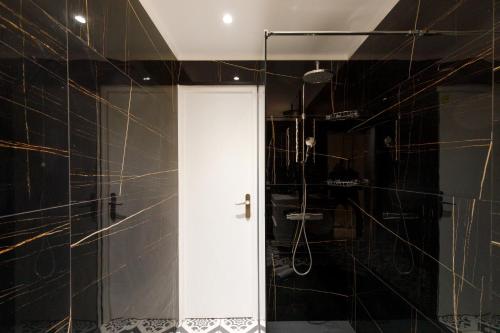 uma casa de banho com um chuveiro e uma porta branca em Cyclades YourHostHelper em Cannes