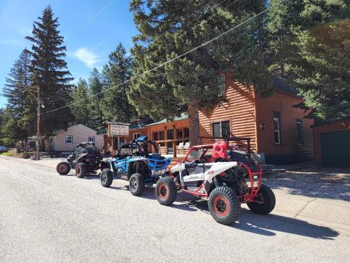 a row of four atvs parked on the side of a street at Allen Gulch Cabins in Hill City