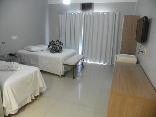 Ένα ή περισσότερα κρεβάτια σε δωμάτιο στο Hotel Ibicui