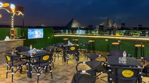 a restaurant with tables and chairs on the roof at night at Happy View Inn in Cairo