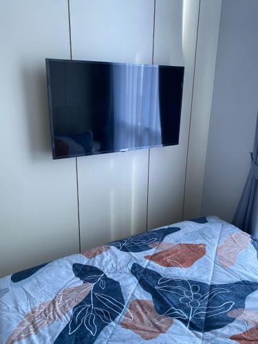 a bedroom with a bed with a flat screen tv at Formosa Spacious Apartments with Netflix & Pick Up Service by MESA in Nagoya