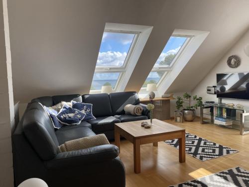 a living room with a couch and a table at Ferienhaus Ostseeblick in Wohlenberg