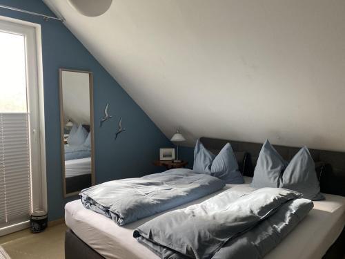 a bedroom with a large bed with a mirror at Ferienhaus Ostseeblick in Wohlenberg