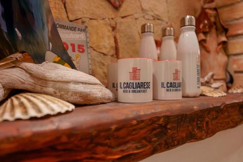a shelf with a bunch of bottles on it at Il Cagliarese B&B in Cagliari