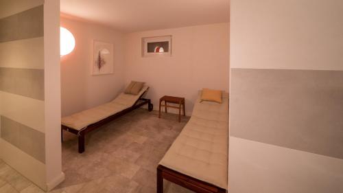 a hospital room with a bed and a chair at Frigga in Nieblum