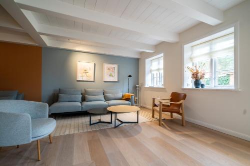 a living room with a couch and chairs and a table at Frigga in Nieblum