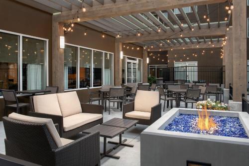 a patio with a fire pit and chairs and tables at SpringHill Suites by Marriott Boise ParkCenter in Boise