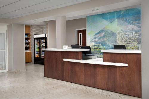 an office lobby with a reception desk and a wall at SpringHill Suites by Marriott Boise ParkCenter in Boise