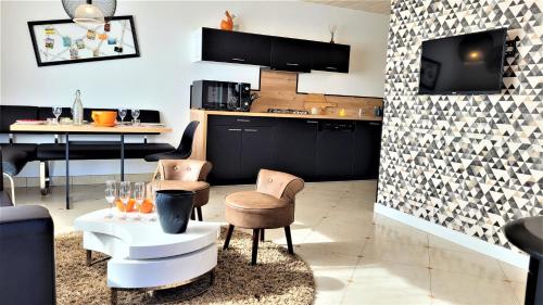 a kitchen with chairs and a table and a counter at Le grand clos, 3 étoiles in Pont-Saint-Martin