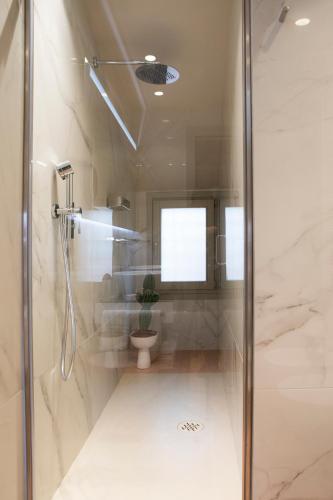 a bathroom with a shower and a toilet at Palazzo Scappi Gardi Luxury Apartments in Bologna