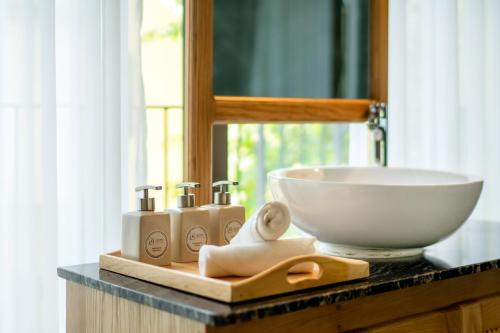 a counter with a sink and a bowl on it at Saca Townhouse by Class6 in Hoi An