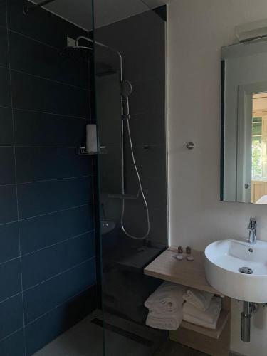 a bathroom with a shower and a sink and a shower at Hotel Baia Delle Sirene in Taormina