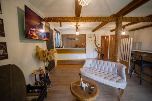 a living room with a white couch and a table at Montana Suite Bungalows in Trabzon