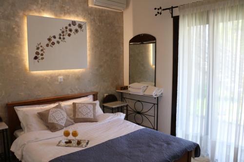 a bedroom with a bed with a tray of oranges on it at MiTerra Cozy Apartments in Andritsaina