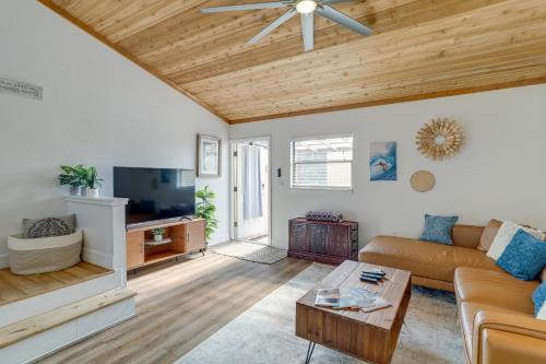 a living room with a couch and a ceiling fan at Breezy Cape Canaveral Townhome about 1 Mi to Beach! in Cape Canaveral