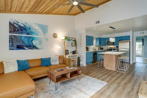 a living room with a couch and a table at Breezy Cape Canaveral Townhome about 1 Mi to Beach! in Cape Canaveral