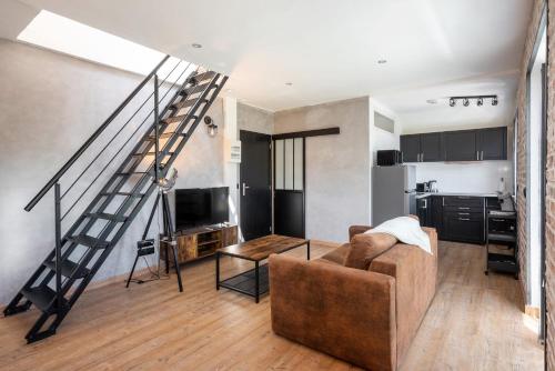 a living room with a couch and a staircase at Superbe Loft industriel - Casa Vostra - CAUTION 800 EUR & ID requises - Gaillard Tram-Frontière in Gaillard