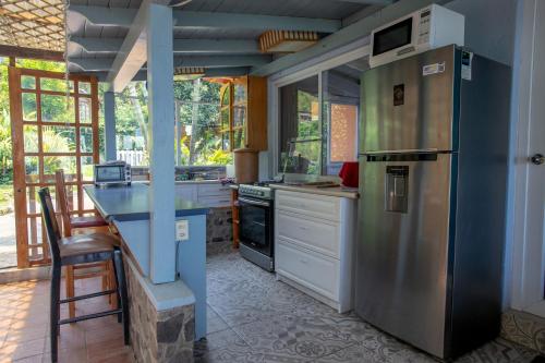 a kitchen with a stainless steel refrigerator and a counter at Lake Front Retreat in Santa Cruz La Laguna