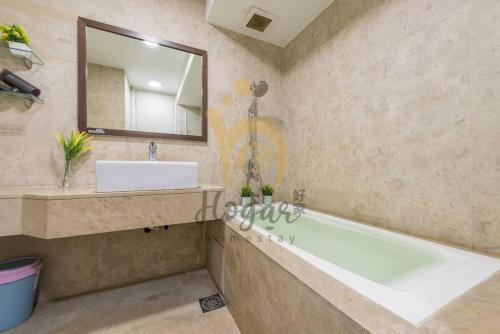 a bathroom with a tub and a sink and a mirror at Myhabitat KLCC 2bedroom Family suite w balcony #bathtub in Kuala Lumpur