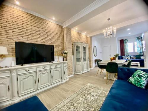 a living room with a tv on a brick wall at Marin Beach Apartment Malvarrosa in Valencia