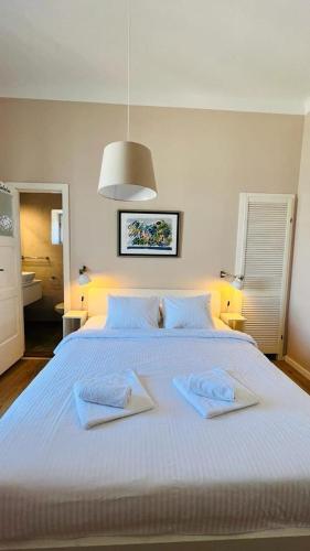 a large white bed with two towels on it at Apartment Marta in Preko