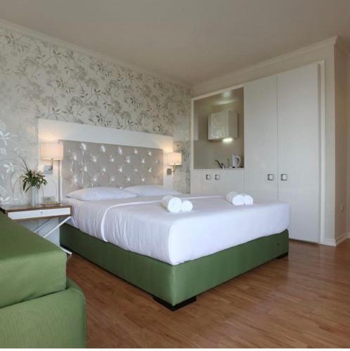 a large bedroom with a large bed with white sheets at Vidikovac Budva in Budva