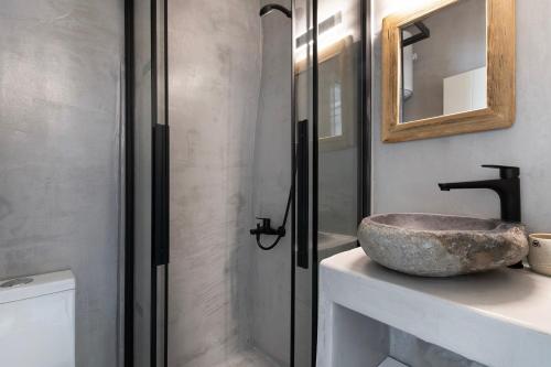 a bathroom with a stone sink on a counter at Afluencia Complex Studio No7 in Naousa