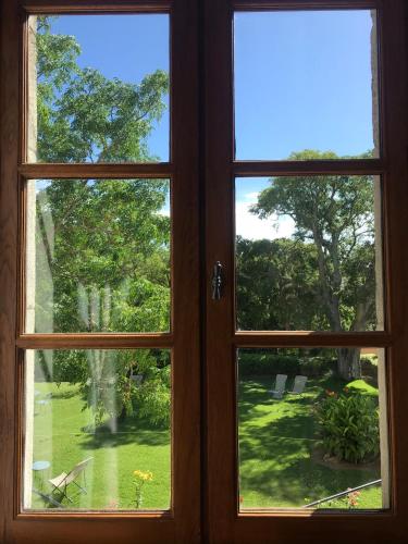 a window with a view of a yard at Logis Hôtel Château De Palaja in Carcassonne