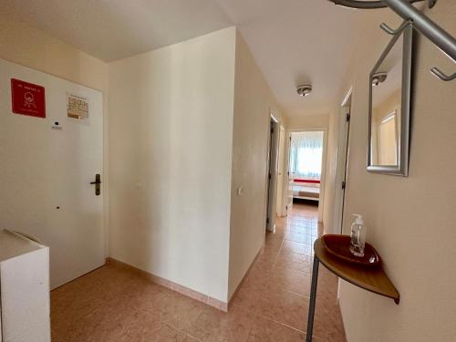 an empty hallway with a table in a room at Las Delas in Denia