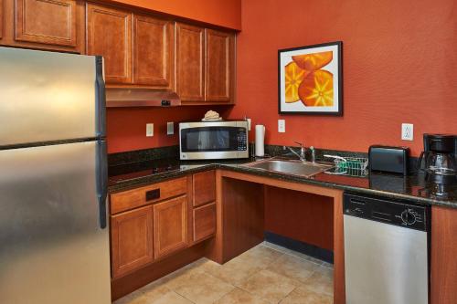 a kitchen with a refrigerator and a microwave at Residence Inn by Marriott Abilene in Abilene