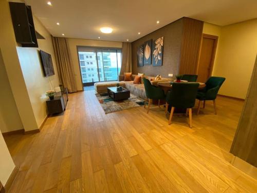 a living room with a couch and a table and chairs at MARINA APARTMENT OCEAN VIEW in Casablanca