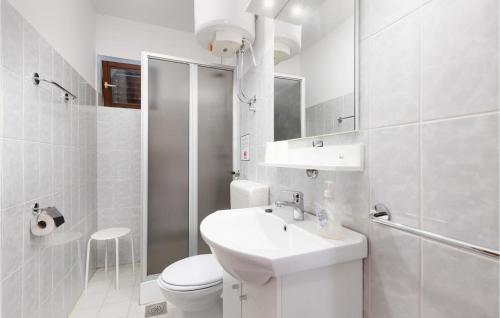 a white bathroom with a sink and a toilet at Awesome Apartment In Krk With 1 Bedrooms And Wifi in Krk