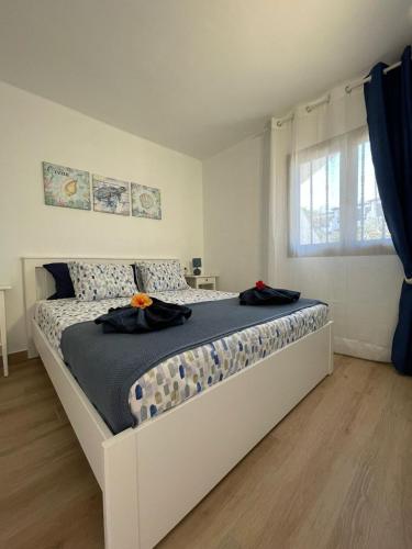 a large white bed in a room with a window at Blue Ocean in Costa Teguise