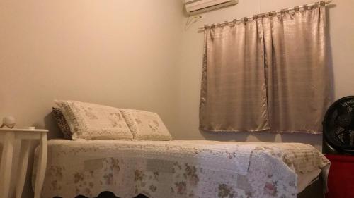 a bedroom with a bed and a window at Casa Completa com Churrasqueira e Jardim em Foz in Foz do Iguaçu