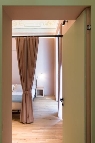 an open door to a bedroom with a bed and a curtain at FilHome 44 in Catania