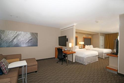 a hotel room with two beds and a television at SpringHill Suites by Marriott Charleston North in Charleston