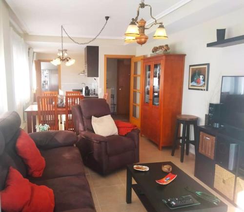 salon z kanapą i stołem w obiekcie Apartamento con jardín Playa Foz w mieście Foz