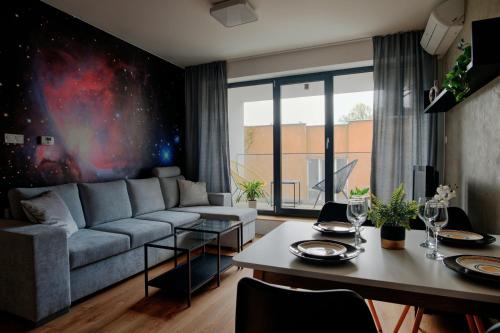 a living room with a couch and a table at Apartmán Kmeťova so súkromným parkovaním zdarma, 5 min pešo do centra in Košice