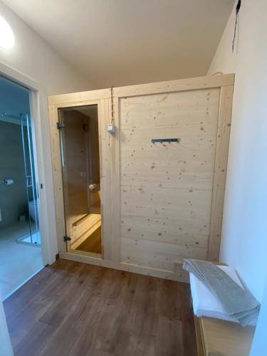 a large wooden door in a room with a wooden floor at Vera Park & Wellness in Belluno
