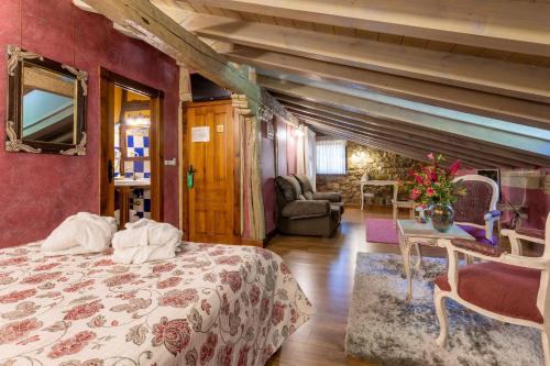 a bedroom with a bed and a living room at Hotel Spa Casona La Hondonada in Terán
