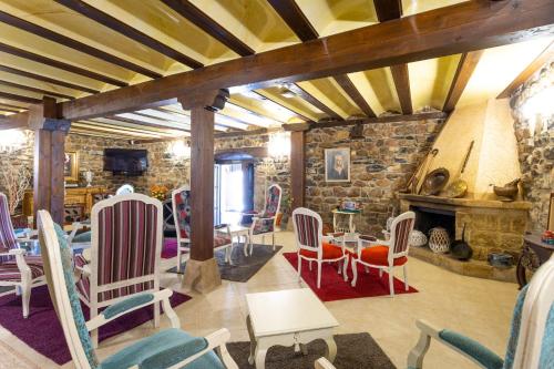 a living room with chairs and a fireplace at Hotel Spa Casona La Hondonada in Terán