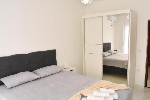 a bedroom with a mirror and a bed at Apartments Amar in Ulcinj