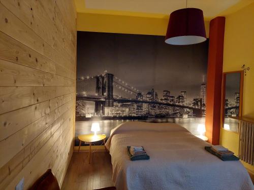 a bedroom with a bed with a painting of a bridge at B&B CountryHouseAnna in Crema
