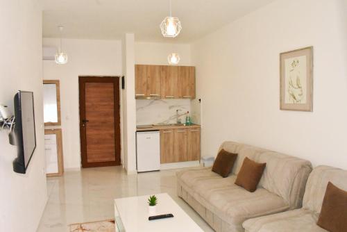 a living room with a couch and a kitchen at Apartments Amar in Ulcinj