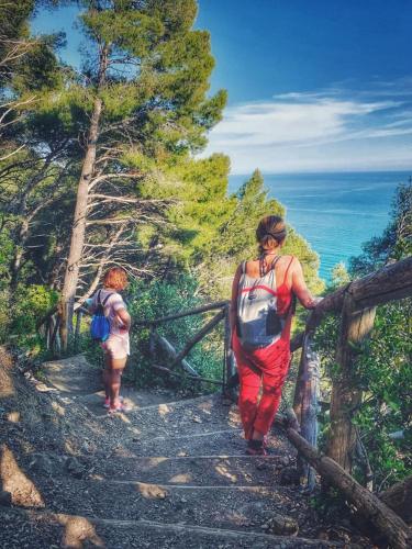 a woman and a child walking down a trail at River Park Hotel in Ameglia