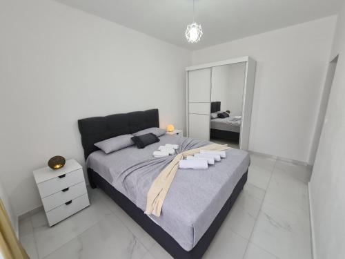 a bedroom with a large bed with towels on it at Apartments Amar in Ulcinj